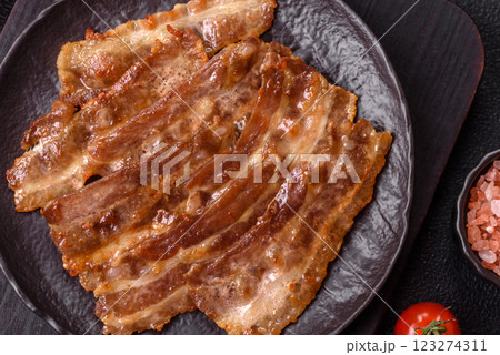 Crispy fried pork bacon sliced with salt, spices and herbs 123274311