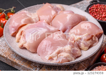 Fresh raw chicken thigh fillets with salt, spices and herbs Fresh raw chicken thigh fillets with salt, spices and herbs 123274359