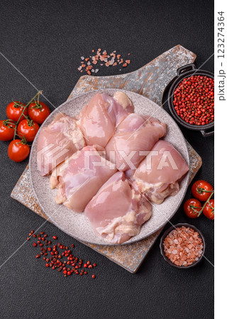 Fresh raw chicken thigh fillets with salt, spices and herbs Fresh raw chicken thigh fillets with salt, spices and herbs 123274364
