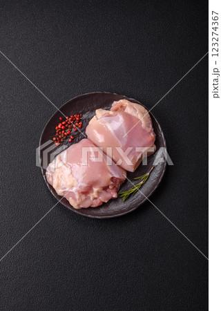 Fresh raw chicken thigh fillets with salt, spices and herbs Fresh raw chicken thigh fillets with salt, spices and herbs 123274367