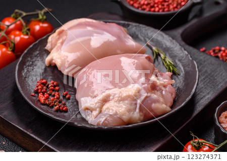 Fresh raw chicken thigh fillets with salt, spices and herbs Fresh raw chicken thigh fillets with salt, spices and herbs 123274371