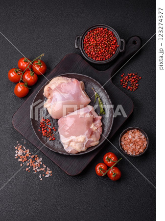 Fresh raw chicken thigh fillets with salt, spices and herbs Fresh raw chicken thigh fillets with salt, spices and herbs 123274377