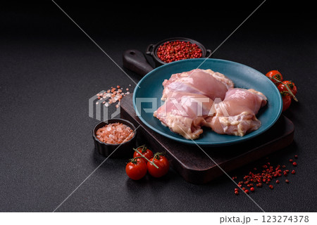 Fresh raw chicken thigh fillets with salt, spices and herbs Fresh raw chicken thigh fillets with salt, spices and herbs 123274378