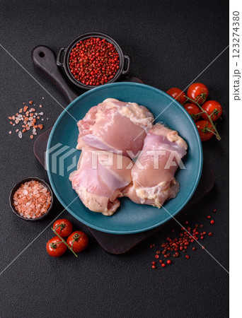 Fresh raw chicken thigh fillets with salt, spices and herbs Fresh raw chicken thigh fillets with salt, spices and herbs 123274380
