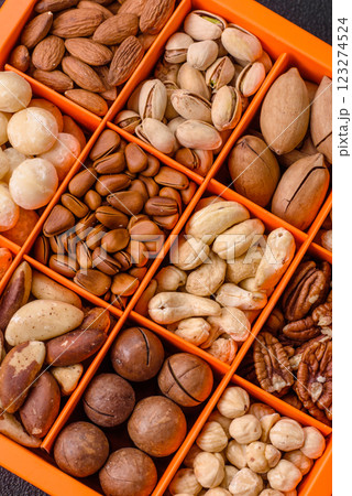 Box with various nuts cashew, macadamia, peanut, cedar, pecan, walnut, brazil, hazelnut 123274524