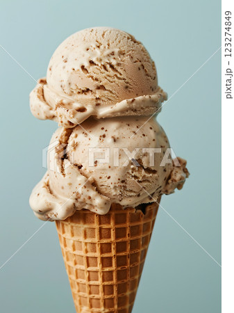 A closeup of a delectable double scoop of speckled ice cream in a crispy waffle cone, ideal for summer and dessert enthusiasts who love cold, creamy, and tempting treats A closeup of a delectable double scoop of speckled ice cream in a crispy waffle cone, ideal for summer and dessert enthusiasts who love cold, creamy, and tempting treats 123274849