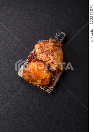 Delicious juicy chicken thighs baked with salt, spices and herbs Delicious juicy chicken thighs baked with salt, spices and herbs 123275079