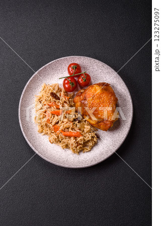 Delicious fresh pilaf with rice, carrots, meat, onions, spices and berries Delicious fresh pilaf with rice, carrots, meat, onions, spices and berries 123275097