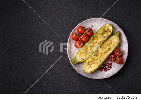 Delicious zucchini cut into two halves baked with salt, spices and herbs Delicious zucchini cut into two halves baked with salt, spices and herbs 123275258