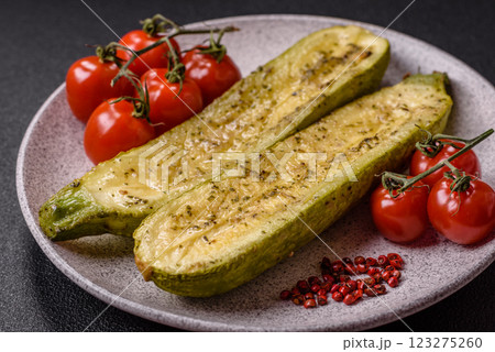 Delicious zucchini cut into two halves baked with salt, spices and herbs 123275260