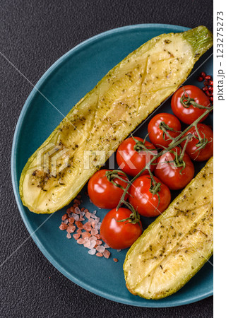 Delicious zucchini cut into two halves baked with salt, spices and herbs Delicious zucchini cut into two halves baked with salt, spices and herbs 123275273