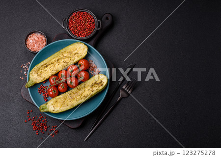 Delicious zucchini cut into two halves baked with salt, spices and herbs Delicious zucchini cut into two halves baked with salt, spices and herbs 123275278