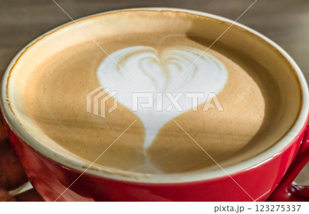 Hot cappuccino coffee with a heart pattern on the foam 123275337