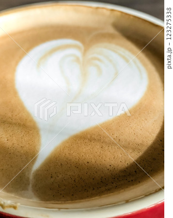 Hot cappuccino coffee with a heart pattern on the foam 123275338