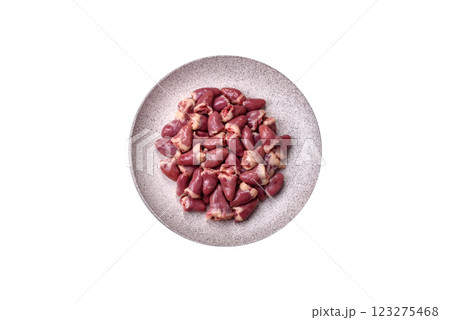 Raw chicken hearts with salt, spices and herbs 123275468