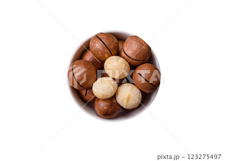 Delicious nutritious macadamia nuts in ceramic bowl Delicious nutritious macadamia nuts in ceramic bowl 123275497