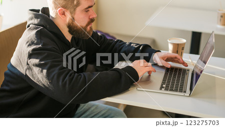 Close-up banner male guy portrait resting in coffee shop chatting in social networks skilled freelancer enjoying remote job typing publication for web blog on laptop copy space Close-up banner male guy portrait resting in coffee shop chatting in social networks skilled freelancer enjoying remote job typing publication for web blog on laptop copy space 123275703