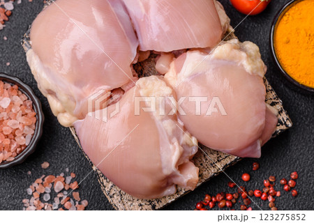 Fresh raw chicken thigh fillets with salt, spices and herbs 123275852