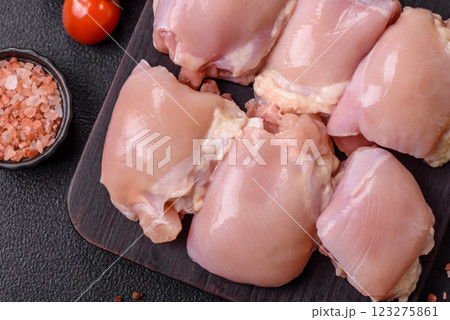 Fresh raw chicken thigh fillets with salt, spices and herbs Fresh raw chicken thigh fillets with salt, spices and herbs 123275861