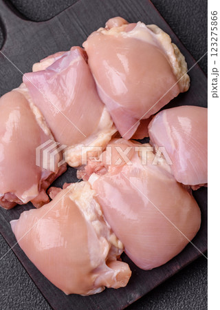 Fresh raw chicken thigh fillets with salt, spices and herbs 123275866