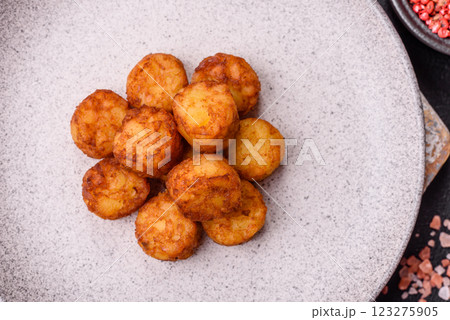 Delicious fried potato balls or croquettes with salt, spices and herbs Delicious fried potato balls or croquettes with salt, spices and herbs 123275905