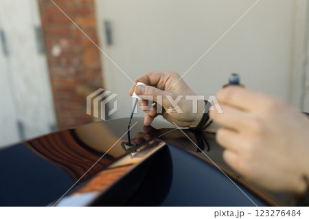 Brush painting small scratches chipped car vehicle detailing paint lacquer 123276484