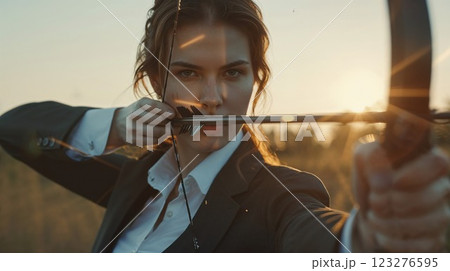 A powerful image of a female archer aiming her bow as the sun sets behind her. The golden light highlights her focused expression and elegant posture, capturing the strength and precision required in A powerful image of a female archer aiming her bow as the sun sets behind her. The golden light highlights her focused expression and elegant posture, capturing the strength and precision required in 123276595