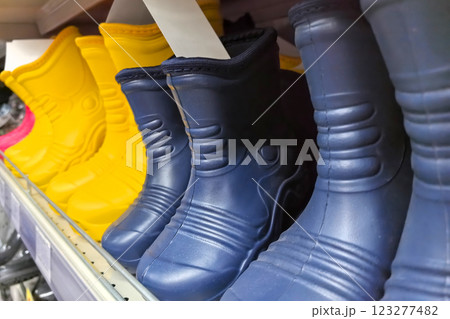 Colorful rubber boots lined up in a store for rainy day adventures Colorful rubber boots lined up in a store for rainy day adventures 123277482