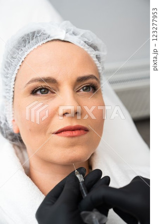 Facial rejuvenation treatment with a client in a clinic setting 123277953