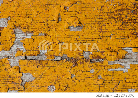 Close-up of the texture of yellow cracked paint. Background image with space for text 123278376