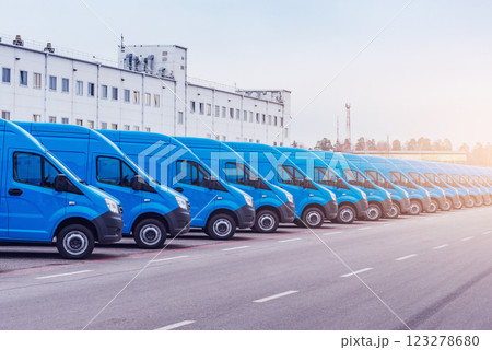 Freight trucks stand by the storage building. 123278680