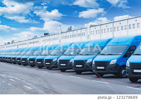 Freight trucks stand by the storage building. Freight trucks stand by the storage building. 123278689