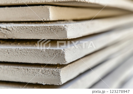Stack of fiber cement boards resting on wooden surface 123278947