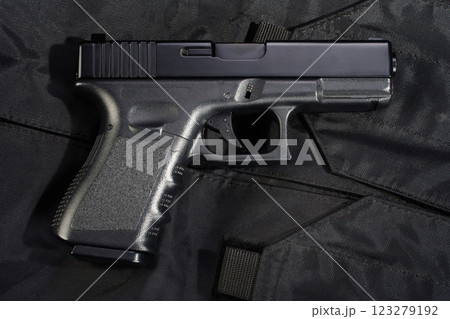 Gun on black police uniform Gun on black police uniform 123279192