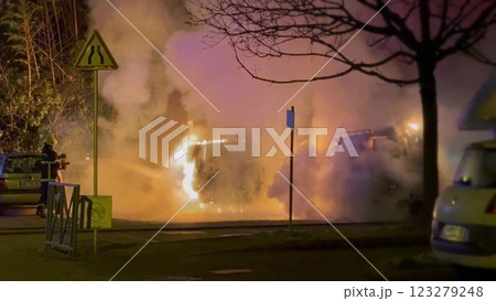 Unknown French firefighter extinguish the burning cars at night 123279248