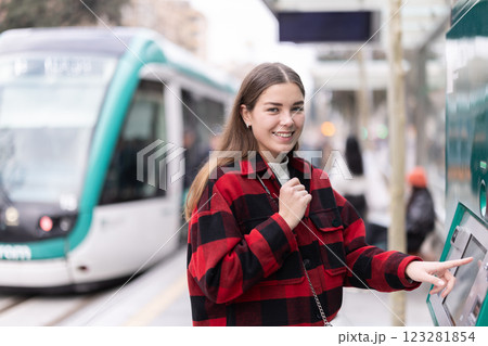 girl pays for a tram fare 123281854
