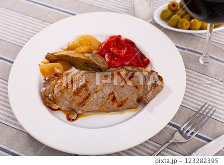 Delicious mediterranian style steak served with baked tomatoes and onions Delicious mediterranian style steak served with baked tomatoes and onions 123282395