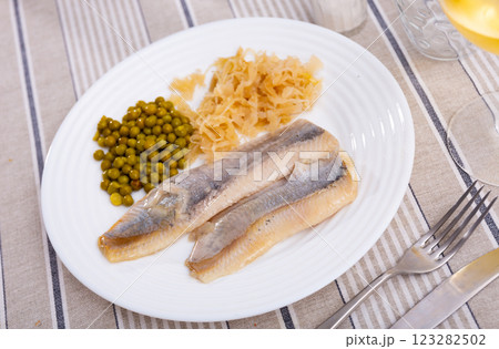 Salted herring fillet with pickled cabbage and green peas 123282502