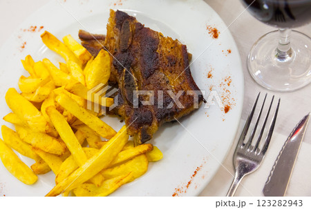 Tasty beef steak with french fries served at plate, spanish dish Tasty beef steak with french fries served at plate, spanish dish 123282943