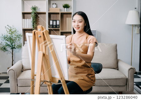 sian Female painter do artwork in art workshop, painting supplies, oil pastels, two canvas easel, creative space sian Female painter do artwork in art workshop, painting supplies, oil pastels, two canvas easel, creative space 123286040
