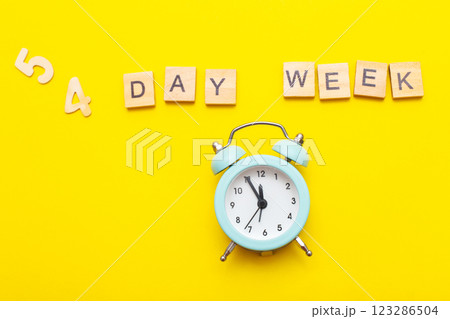 inscription four day week making by wooden cubes on yellow background 123286504