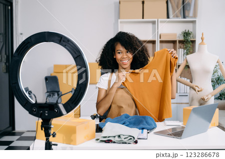 Fashion blogger concept, Young women selling clothes on video streaming.Startup small business SME, using smartphone Fashion blogger concept, Young women selling clothes on video streaming.Startup small business SME, using smartphone 123286678