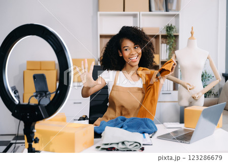 Startup small business SME, Entrepreneur owner woman using smartphone or tablet taking receive and checking online purchase shopping order 123286679