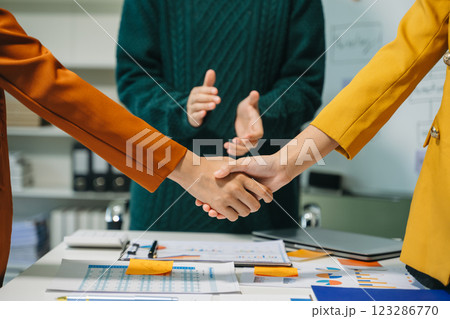 Two confident business man shaking hands during a meeting in the office, success, dealing, greeting and partner 123286770