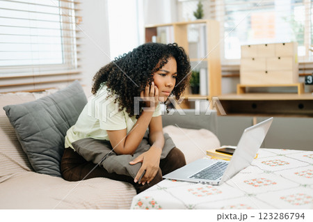 Young woman using a tablet in a cozy home, capturing creativity, relaxation, and digital connection 123286794