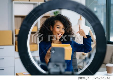 Fashion blogger concept, Young women selling clothes on video streaming.Startup small business SME, using smartphone or tablet taking Fashion blogger concept, Young women selling clothes on video streaming.Startup small business SME, using smartphone or tablet taking 123286938