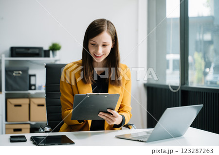 Business woman sitting at a desk using a laptop computer Navigating Finance and Marketing with Technology Business woman sitting at a desk using a laptop computer Navigating Finance and Marketing with Technology 123287263