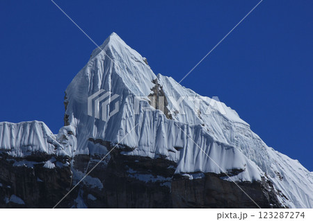 Blue sky over the pointed peak Lobuche East, Nepal. 123287274