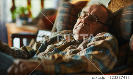 Senior man napping peacefully in a chair. 123287452