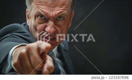 Angry man pointing finger with fierce look. 123287696